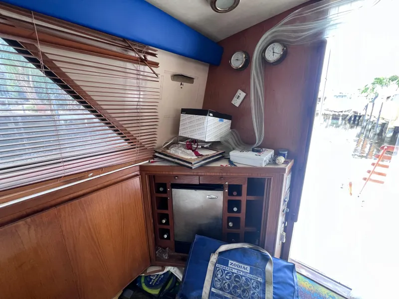 Slide: The Image of 1988 Bertram 43 Convertible interior with wooden cabinetry and mini fridge. - 46