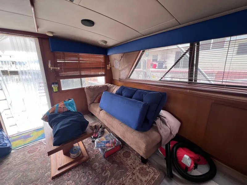 Slide: The Image of Interior of a 1988 Bertram 43 Convertible yacht with sofa and wooden blinds. - 47