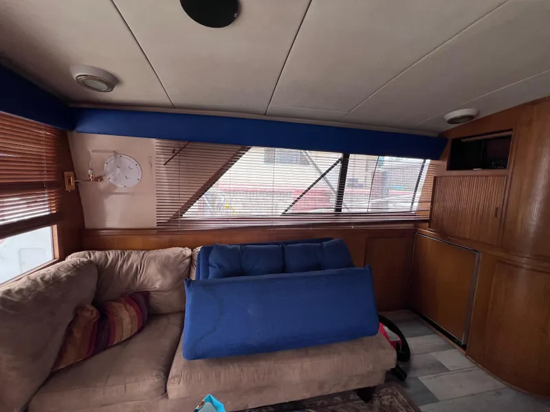 Slide: The Image of Interior of 1988 Bertram 43 Convertible yacht with beige sofa and wooden cabinetry. - 49