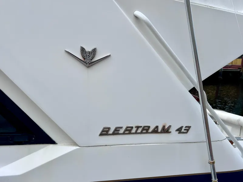 Slide: The Image of 1988 Bertram 43 Convertible yacht side view with logo and model name. - 5
