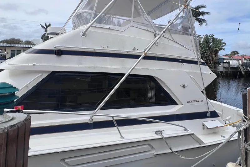 Slide: The Image of 1988 Bertram 43 Convertible yacht docked at a marina. - 8