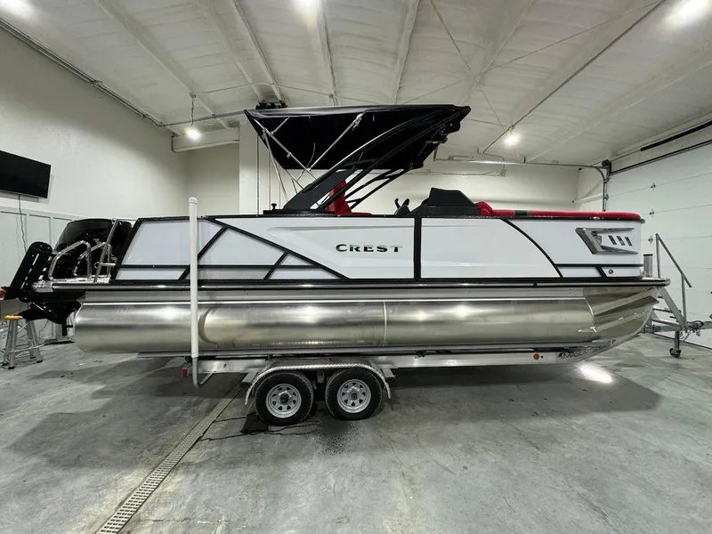 Slide: The Image of 2024 Crest Caribbean RS 230 SLRC pontoon boat in showroom with ladder access. - 15