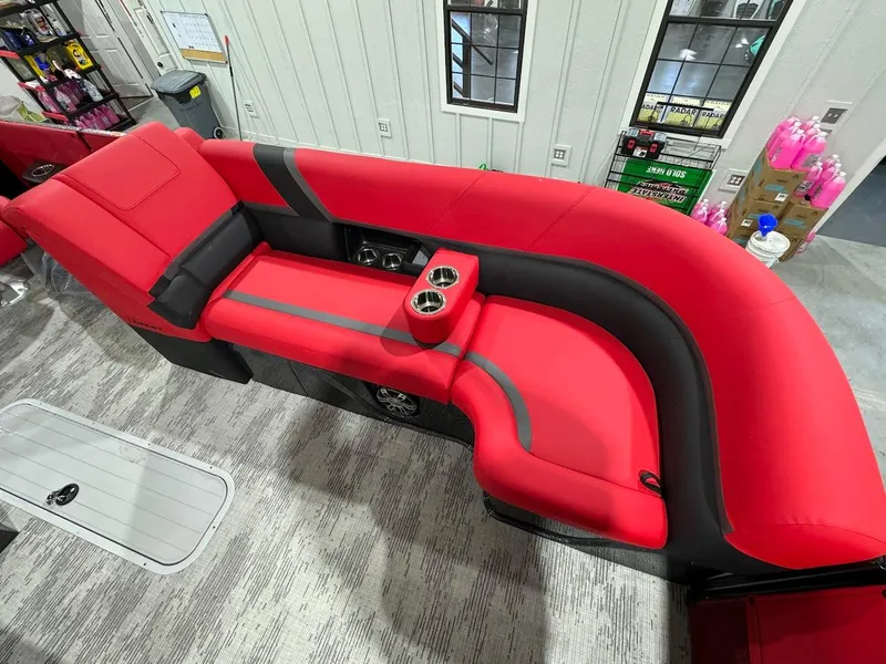 Slide: The Image of 2024 Crest Caribbean RS 230 SLRC pontoon boat on trailer in showroom. - 17