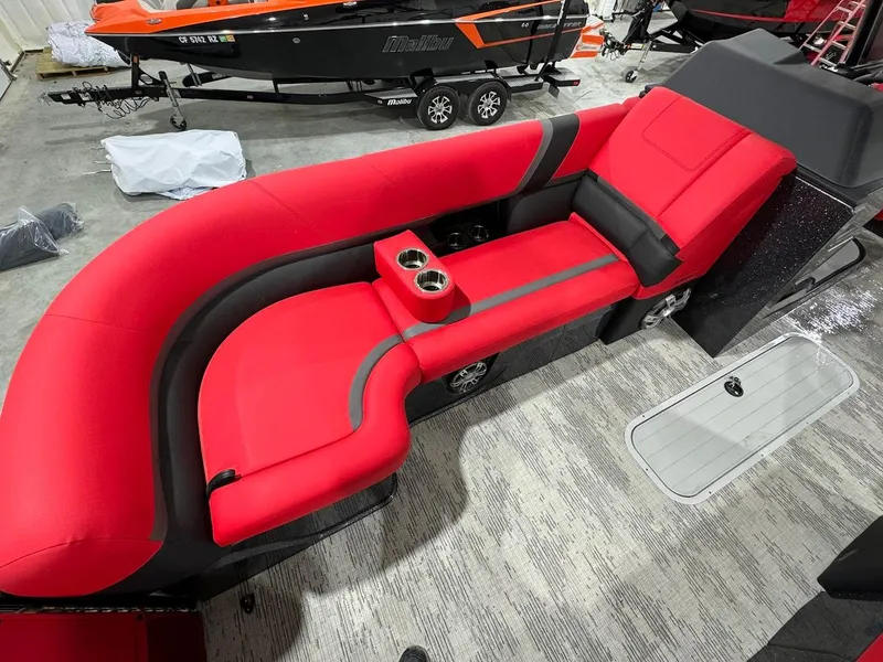 Slide: The Image of 2024 Crest Caribbean RS 230 SLRC pontoon boat on trailer in showroom. - 18