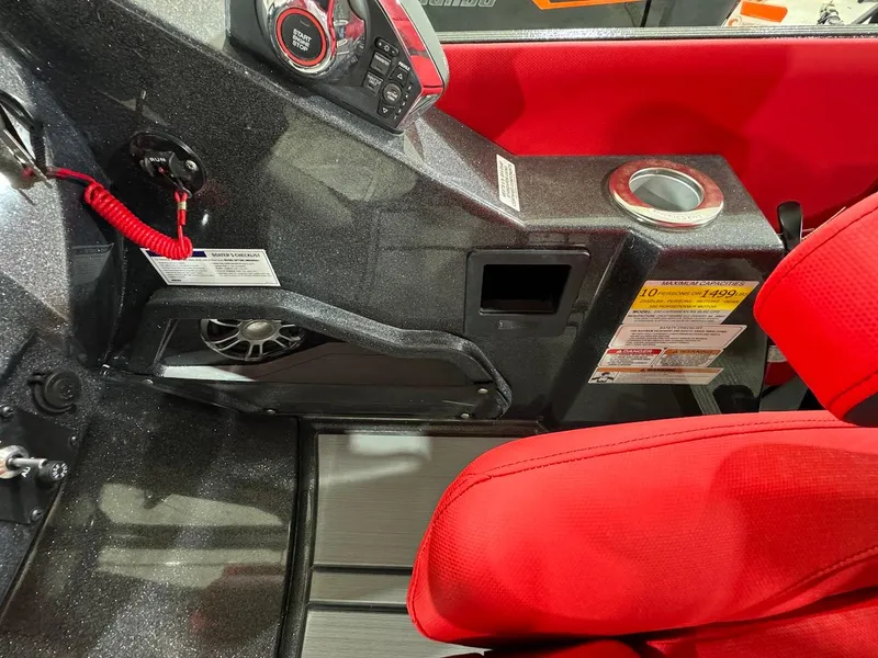 Slide: The Image of 2024 Crest Caribbean RS 230 SLRC boat interior with red seating and modern dashboard. - 26