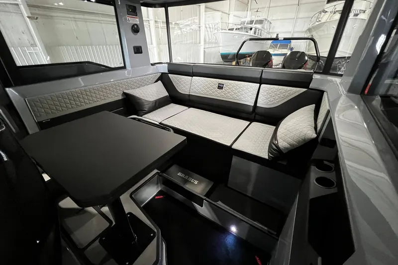 Slide: The Image of Luxurious interior of 2024 BRABUS Shadow 1000XC with quilted seating and sleek table design. - 14