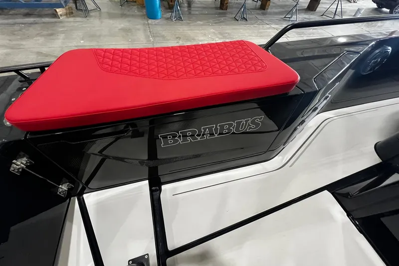 Slide: The Image of 2024 BRABUS Shadow 1000XC with red cushioned seat and sleek black design. - 5