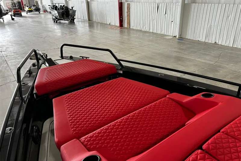 Slide: The Image of 2024 BRABUS Shadow 1000XC with luxurious red quilted seating in a spacious warehouse. - 7