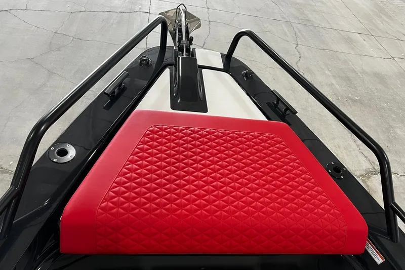 Slide: The Image of 2024 BRABUS Shadow 1000XC boat with red quilted seating and sleek black rails. - 8