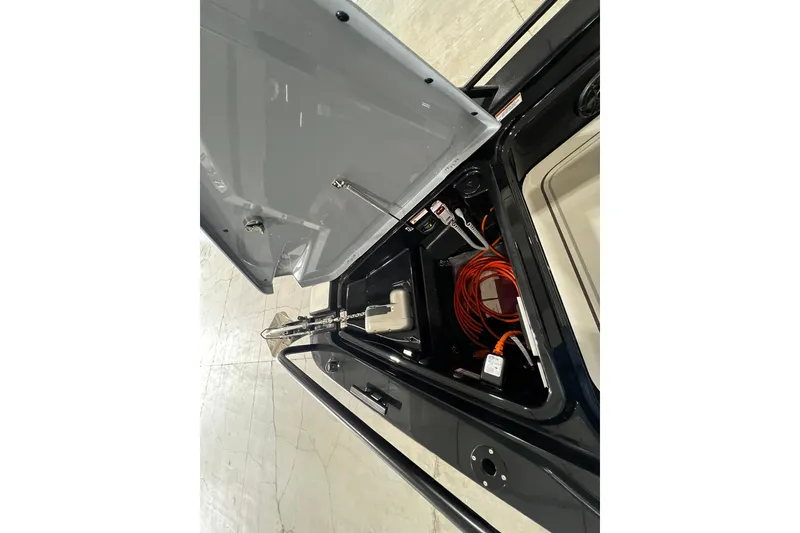 Slide: The Image of 2024 BRABUS Shadow 1000XC storage compartment with tools and cables. - 9