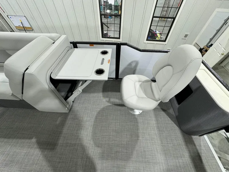 Slide: The Image of 2024 Crest Classic LX 220 boat interior with seating and table. - 10