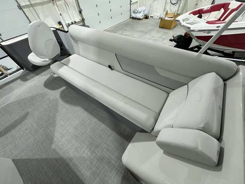 Slide: The Image of 2024 Crest Classic LX 220 boat interior with gray seating and carpet. - 11