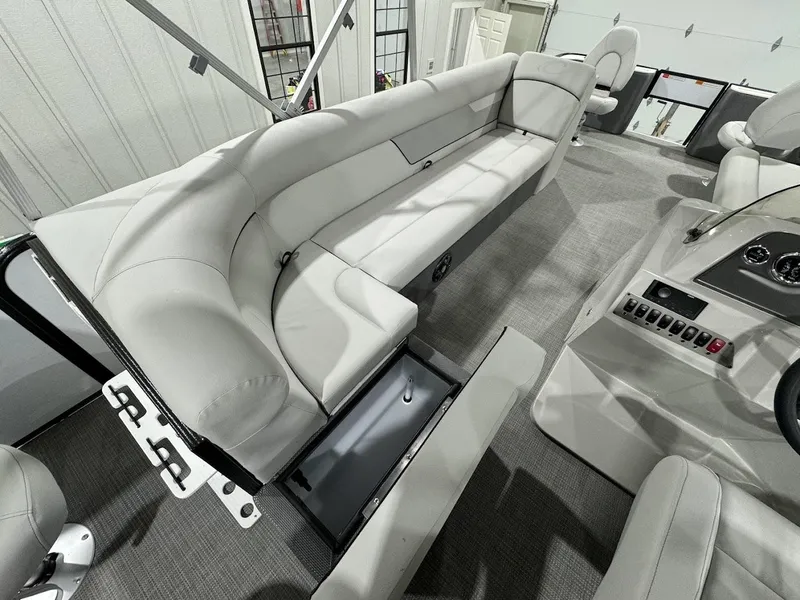 Slide: The Image of 2024 Crest Classic LX 220 boat interior with spacious seating and storage compartments. - 12