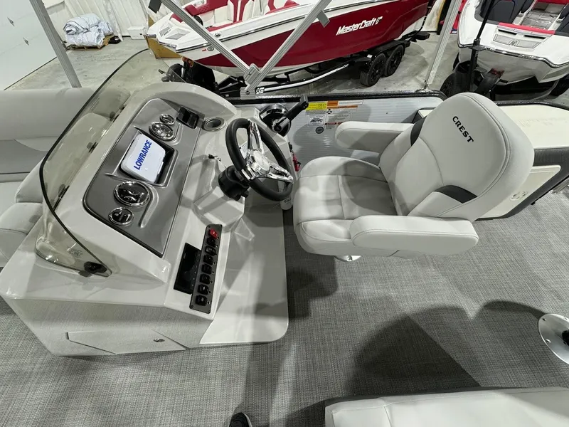 Slide: The Image of 2024 Crest Classic LX 220 boat interior with captain's chair and control console. - 13