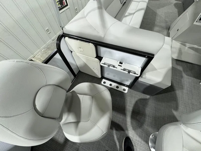 Slide: The Image of 2024 Crest Classic LX 220 boat interior with seating and storage compartments. - 19