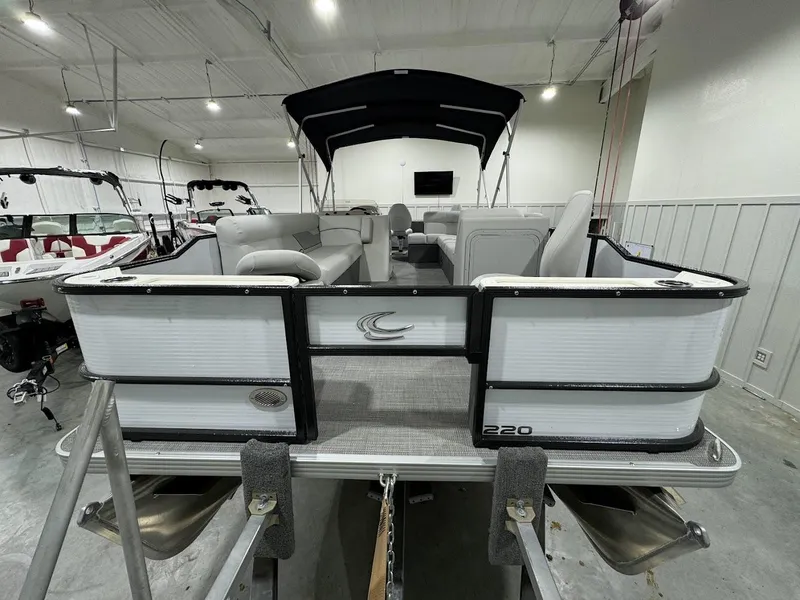 Slide: The Image of 2024 Crest Classic LX 220 pontoon boat in showroom. - 4