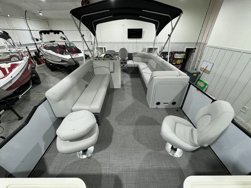 Slide: The Image of 2024 Crest Classic LX 220 pontoon boat interior with gray seating and modern design. - 5