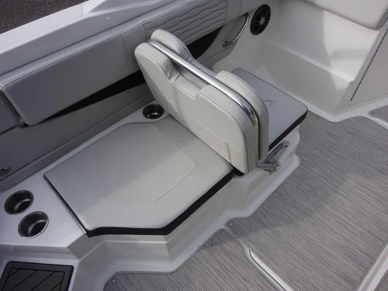 Slide: The Image of 2023 Sea Ray SPX 210 boat interior seating with cup holders and speaker. - 10