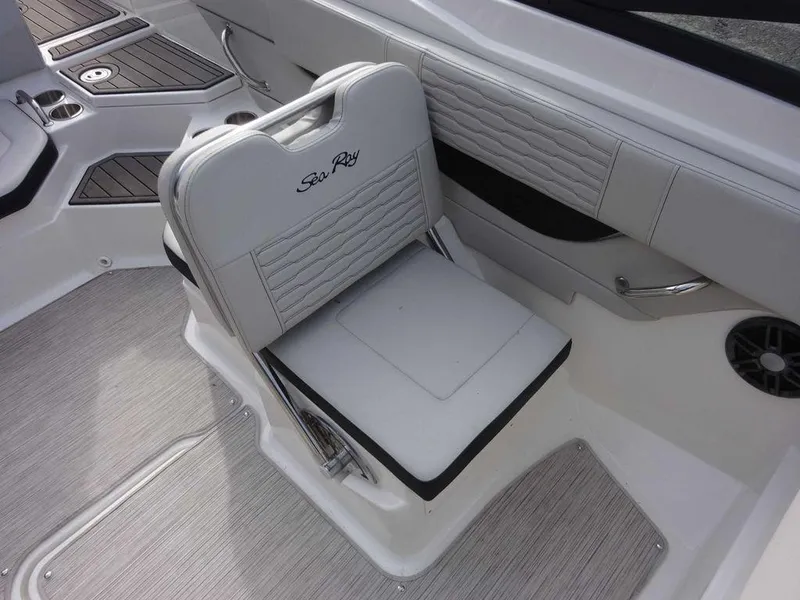 Slide: The Image of 2023 Sea Ray SPX 210 boat interior with white cushioned seating. - 11