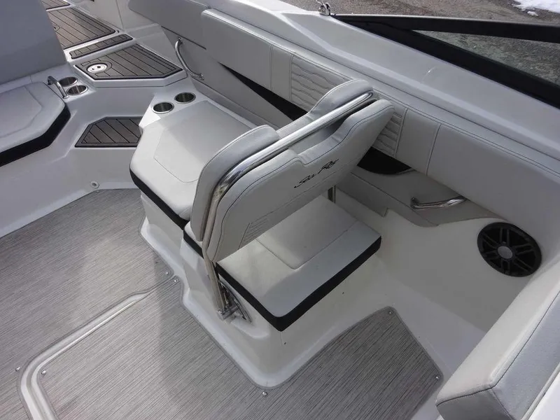 Slide: The Image of 2023 Sea Ray SPX 210 boat interior with white seating and cup holders. - 14