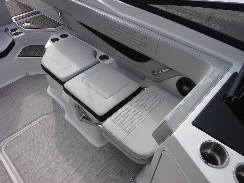 Slide: The Image of 2023 Sea Ray SPX 210 boat interior seating with cup holders and modern design. - 15