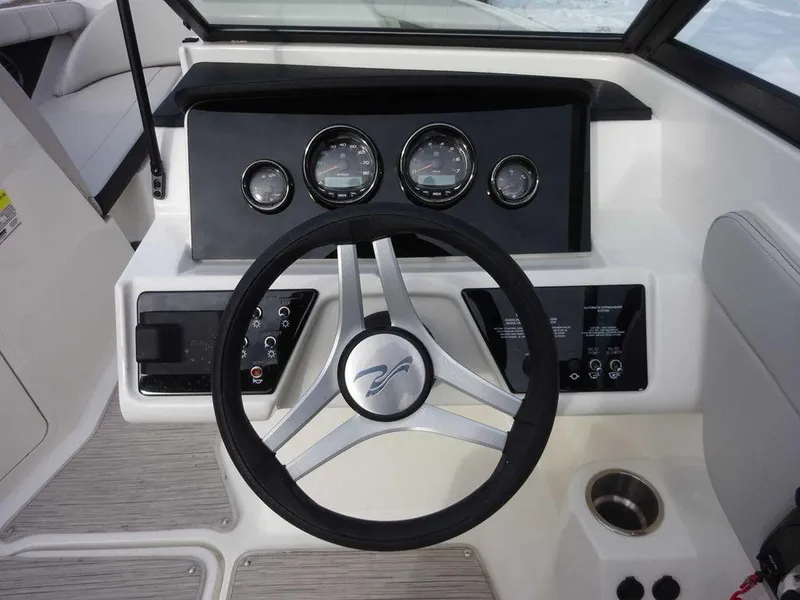 Slide: The Image of 2023 Sea Ray SPX 210 boat dashboard with steering wheel and gauges. - 16