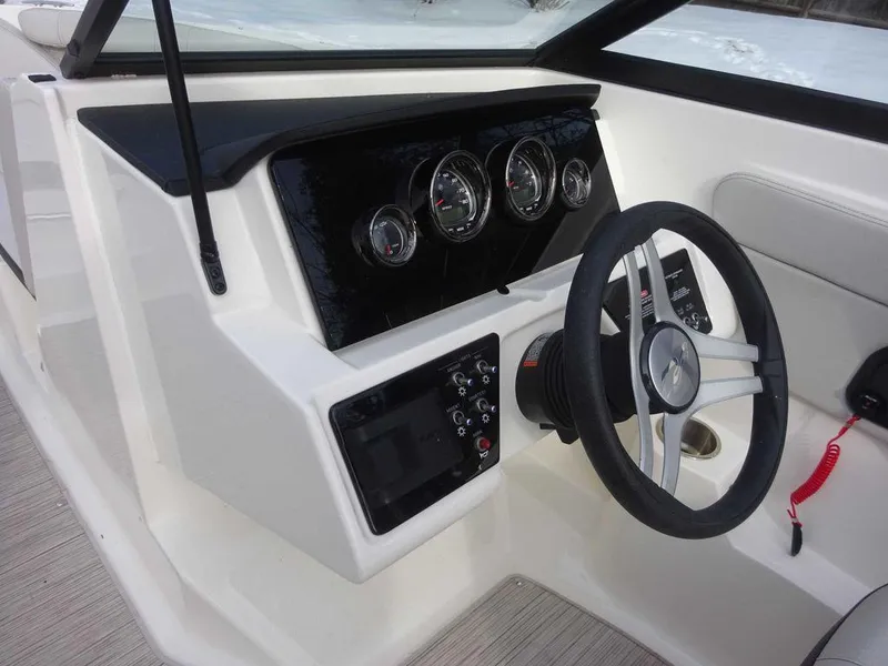 Slide: The Image of 2023 Sea Ray SPX 210 boat dashboard with steering wheel and instrument panel. - 17