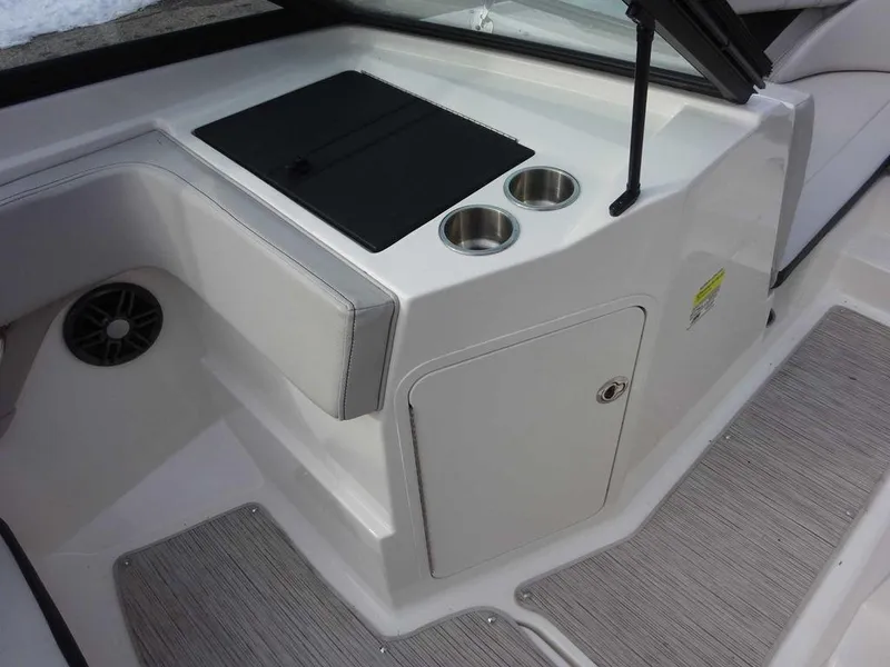 Slide: The Image of 2023 Sea Ray SPX 210 boat interior with cup holders and storage compartment. - 20