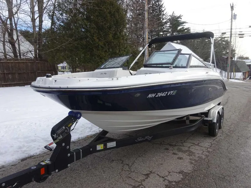 Slide: The Image of 2023 Sea Ray SPX 210 boat on a trailer in a snowy driveway. - 3