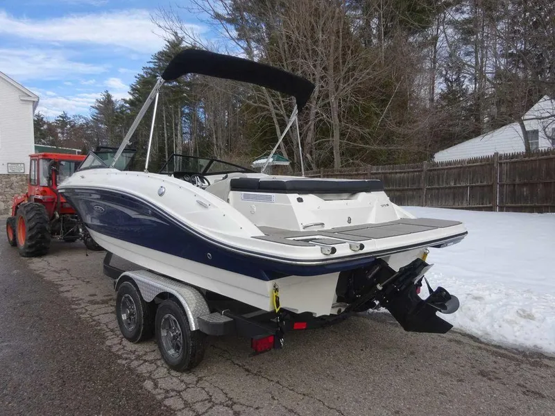 Slide: The Image of 2023 Sea Ray SPX 210 boat on trailer, parked on a snowy driveway. - 5