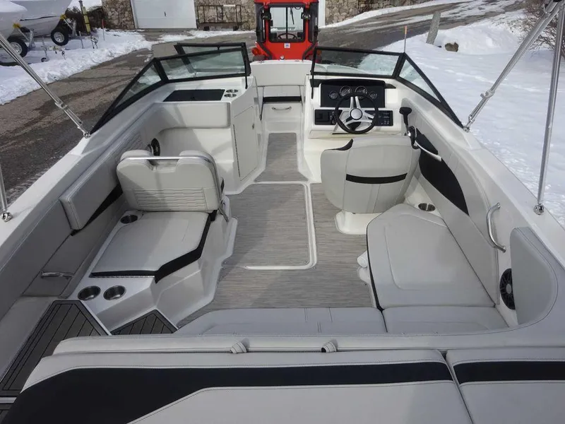 Slide: The Image of 2023 Sea Ray SPX 210 boat interior with modern seating and steering console. - 6