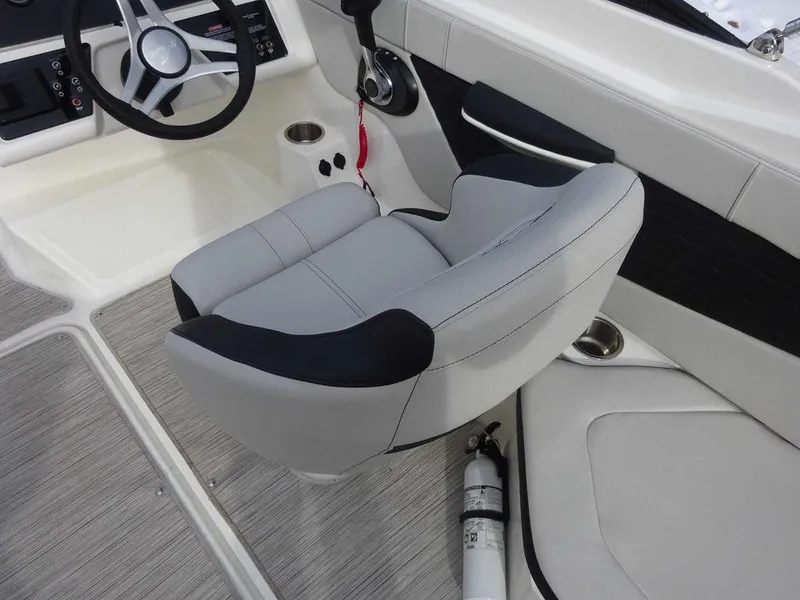 Slide: The Image of 2023 Sea Ray SPX 210 boat interior with captain's chair and steering wheel. - 7