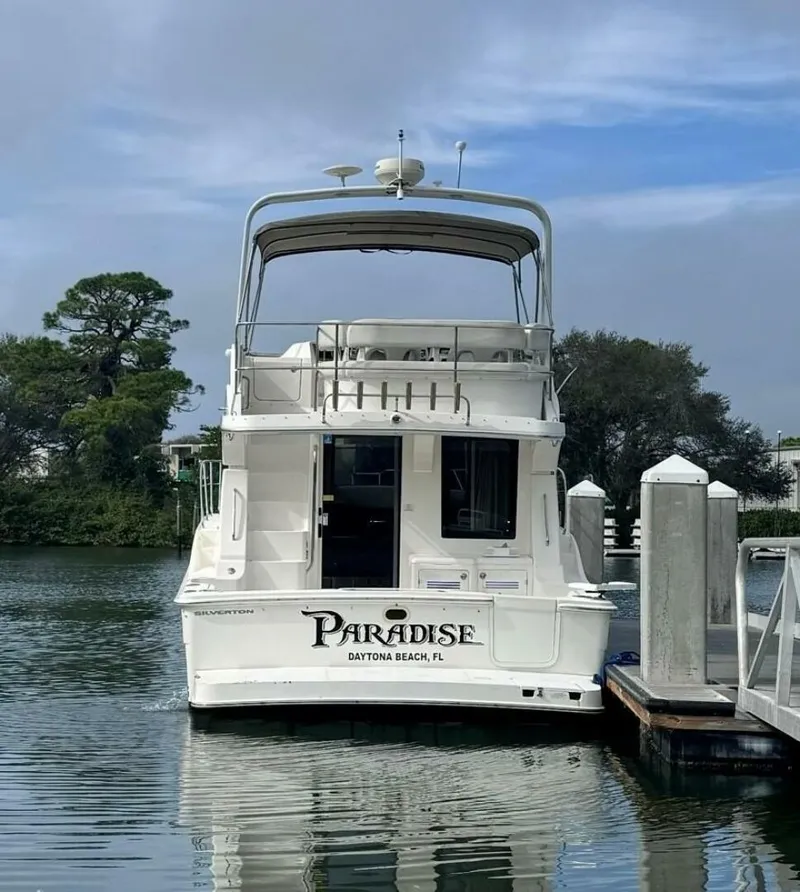 Slide: The Image of 2005 Silverton 34 Convertible boat docked, named Paradise, in Daytona Beach, FL. - 11