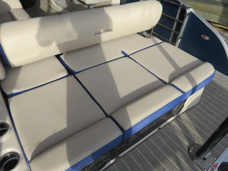 Slide: The Image of 2022 Harris Grand Mariner 250 boat with beige cushioned seating. - 4