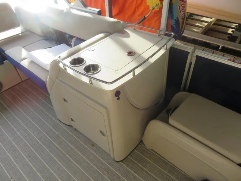 Slide: The Image of Interior of a 2022 Harris Grand Mariner 250 boat with seating and storage. - 8