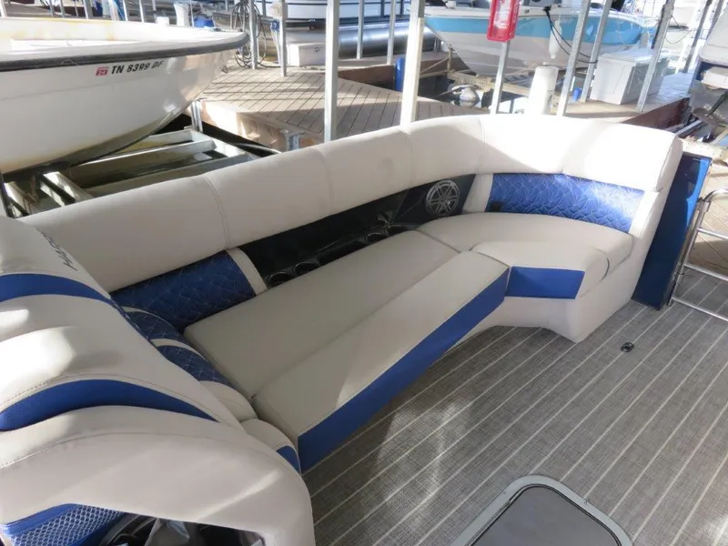 Slide: The Image of 2022 Harris Grand Mariner 250 boat interior with beige and blue seating. - 9