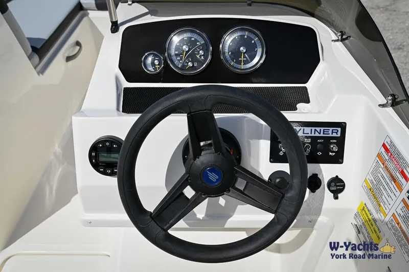 Slide: The Image of 2024 Bayliner M19 boat dashboard with steering wheel and instrument panel. - 10