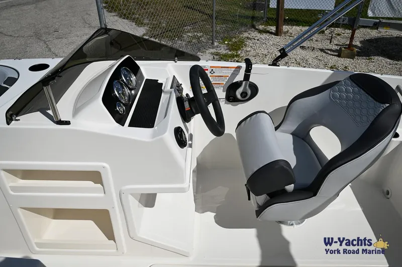 Slide: The Image of 2024 Bayliner M19 boat cockpit with steering wheel and captain's chair at W-Yachts York Road Marine. - 11
