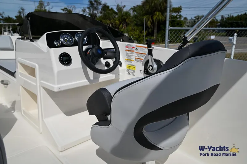 Slide: The Image of 2024 Bayliner M19 boat cockpit with steering wheel and control panel. - 12