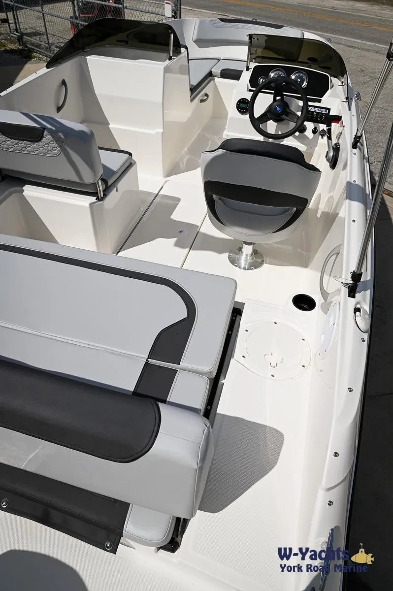 Slide: The Image of 2024 Bayliner M19 boat interior with seating and steering console. - 18