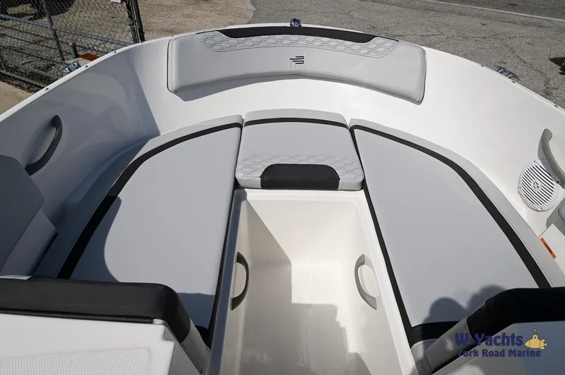 Slide: The Image of 2024 Bayliner M19 boat interior with cushioned seating and storage compartments. - 3