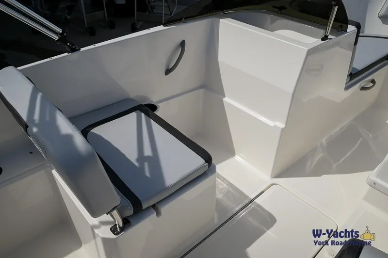 Slide: The Image of 2024 Bayliner M19 boat interior with seating and storage. - 6