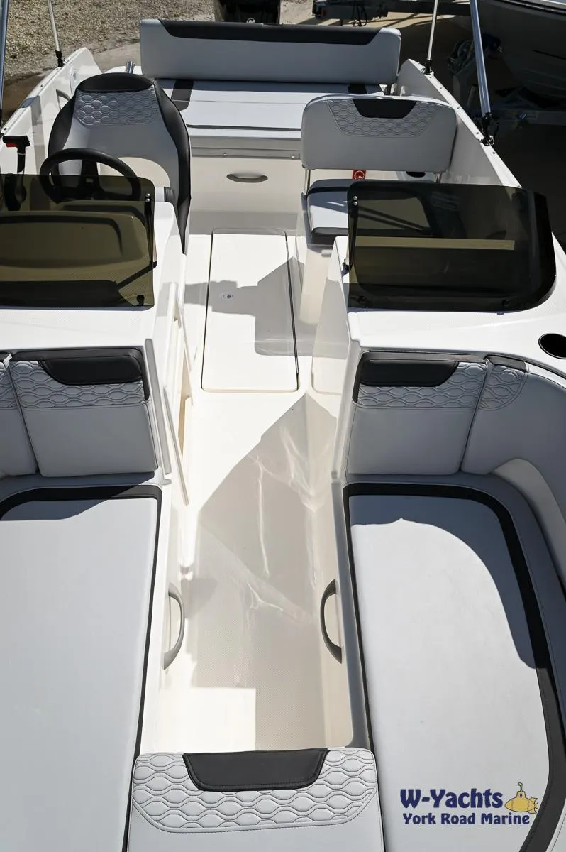 Slide: The Image of 2024 Bayliner M19 boat interior with seating and console, displayed by W-Yachts York Road Marine. - 7