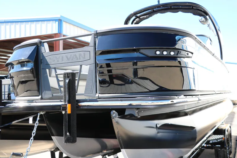 Slide: The Image of 2024 Sylvan G5 CLZ DC pontoon boat, sleek black exterior, docked at marina. - 15