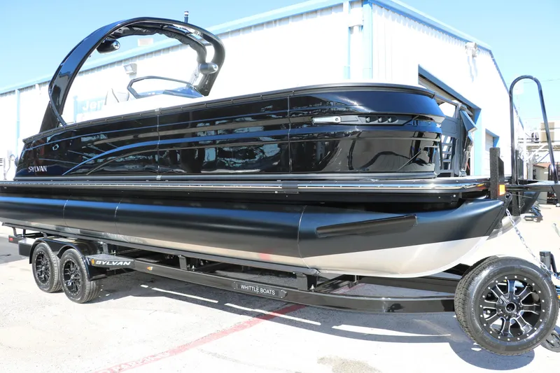Slide: The Image of 2024 Sylvan G5 CLZ DC pontoon boat on trailer outside warehouse. - 2