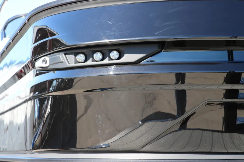 Slide: The Image of Close-up of 2024 Sylvan G5 CLZ DC boat's sleek black exterior and LED lights. - 22