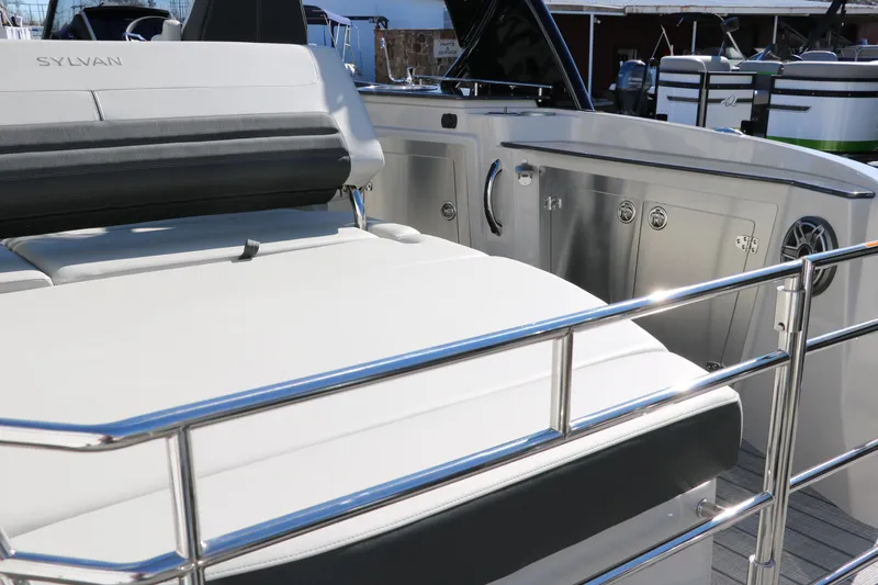 Slide: The Image of 2024 Sylvan G5 CLZ DC boat interior with stainless steel railing and cushioned seating. - 32