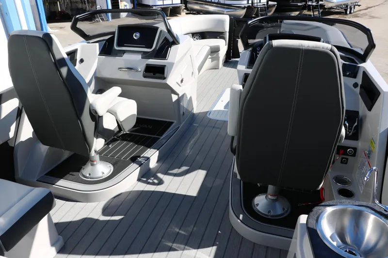 Slide: The Image of 2024 Sylvan G5 CLZ DC boat interior with dual captain's chairs and modern dashboard. - 34