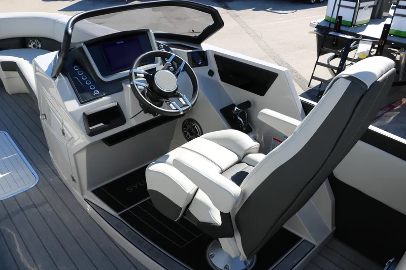 Slide: The Image of 2024 Sylvan G5 CLZ DC boat cockpit with modern steering wheel and control panel. - 36