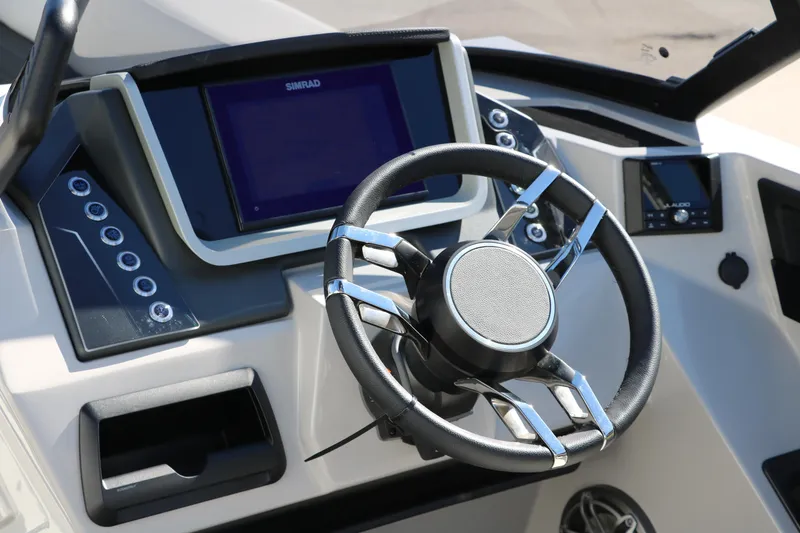 Slide: The Image of 2024 Sylvan G5 CLZ DC boat dashboard with steering wheel and touchscreen display. - 37